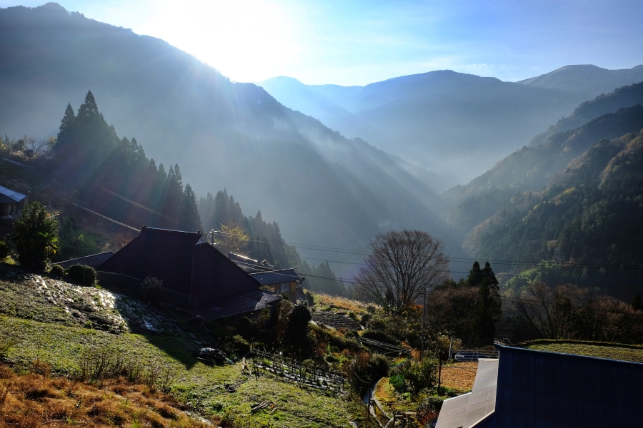 Morning sunlight illuminates a Japanese valley